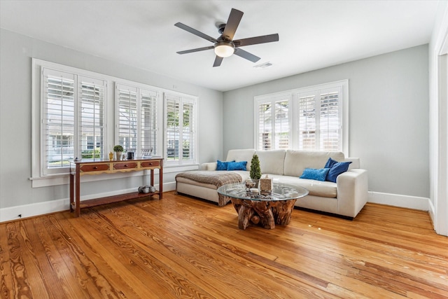 719 Key St, Houston, TX 77009 - living room featuring baseboards, wood finished floors, and a ceiling fan