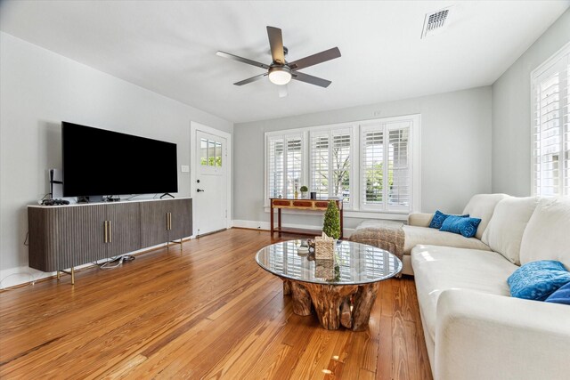 719 Key St, Houston, TX 77009 - living area with a ceiling fan, wood finished floors, and plenty of natural light