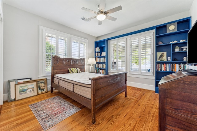 719 Key St, Houston, TX 77009 - bedroom with light wood-type flooring, baseboards, and ceiling fan