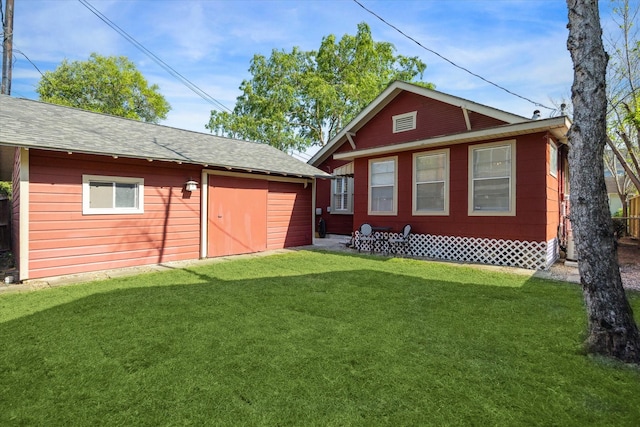 719 Key St, Houston, TX 77009 - rear view of property with a lawn, an outdoor structure, and roof with shingles