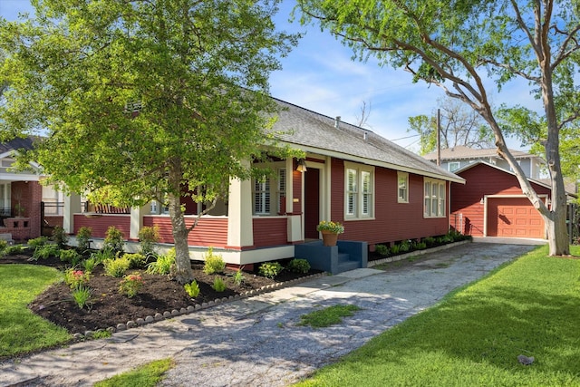 719 Key St, Houston, TX 77009 - view of front of home featuring an outbuilding, asphalt driveway, a porch, a front lawn, and roof with shingles