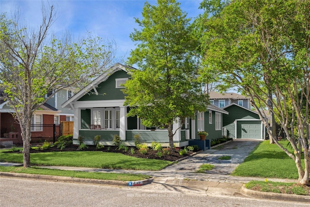 719 Key St, Houston, TX 77009 - view of front of property with a detached garage, driveway, and an outbuilding