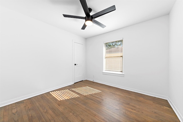 unfurnished room featuring dark wood-type flooring, baseboards, and a ceiling fan