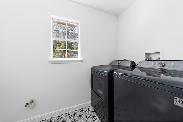 clothes washing area featuring washer and dryer, laundry area, baseboards, and tile patterned flooring