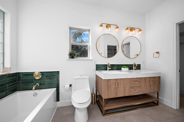 bathroom featuring a sink, toilet, double vanity, and a garden tub
