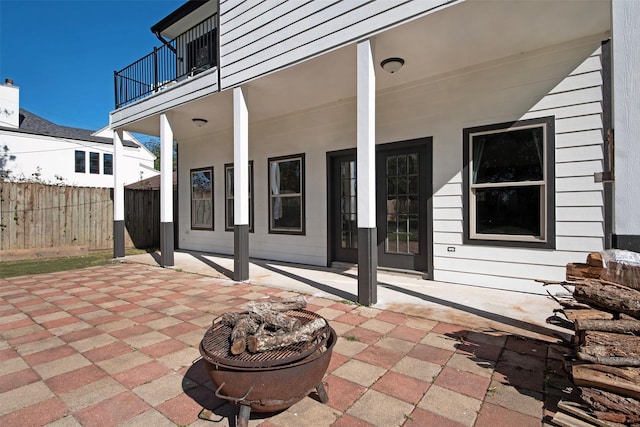 view of patio / terrace featuring fence and a balcony