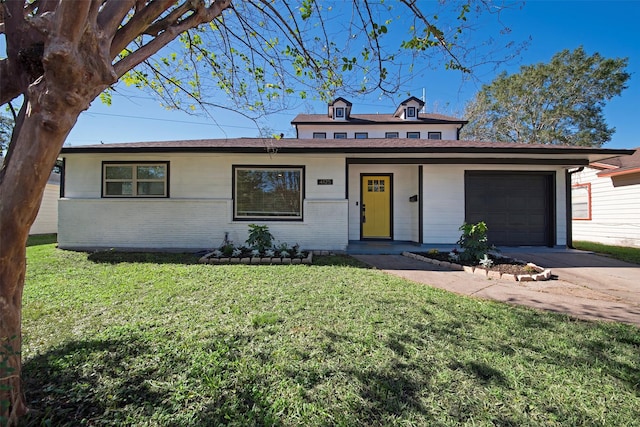 view of front of home featuring concrete driveway, a front yard, brick siding, and an attached garage