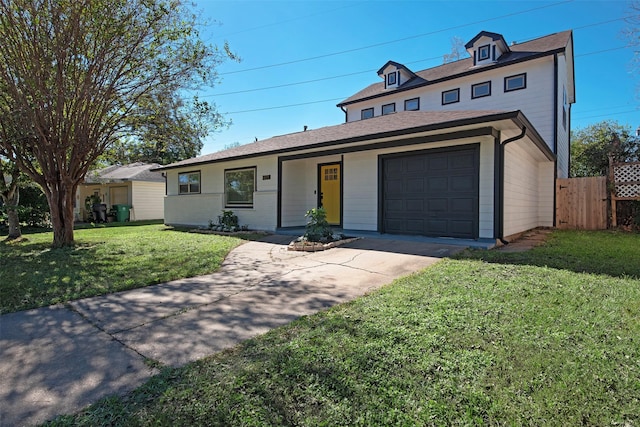view of front of home with concrete driveway, a front yard, fence, and a garage