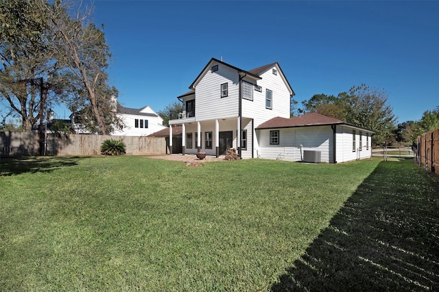 back of property featuring a patio area, central AC unit, a fenced backyard, and a lawn