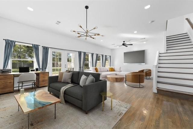 living room with recessed lighting, stairs, french doors, and wood finished floors