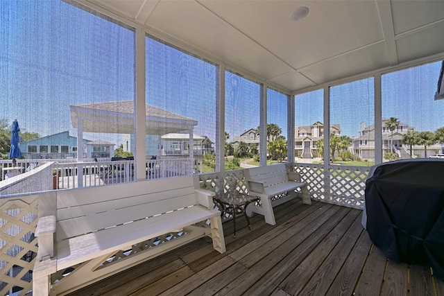 sunroom featuring a residential view