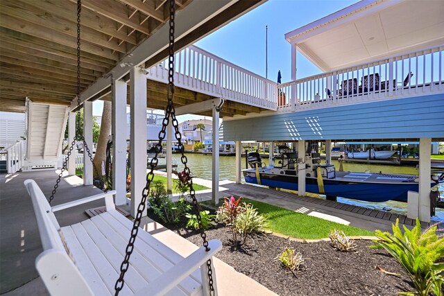 dock area featuring boat lift and a water view