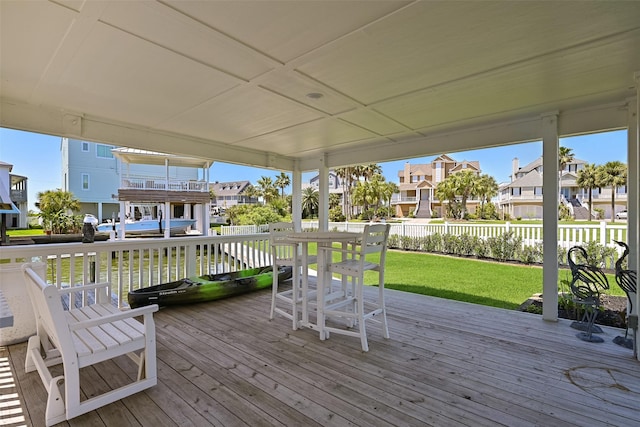 wooden deck with a residential view, a yard, and fence