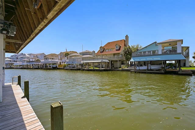 dock area featuring a residential view and a water view