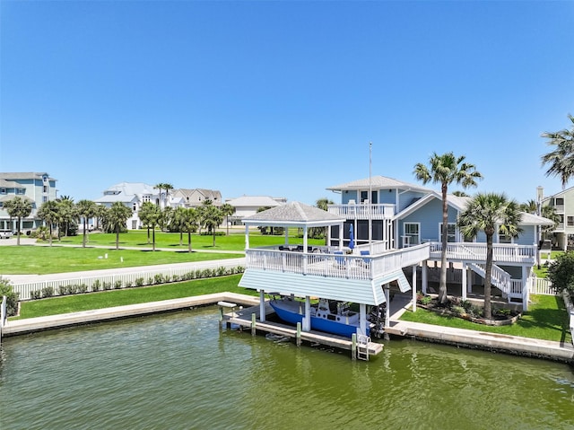 dock area with a water view, a lawn, boat lift, stairway, and a residential view