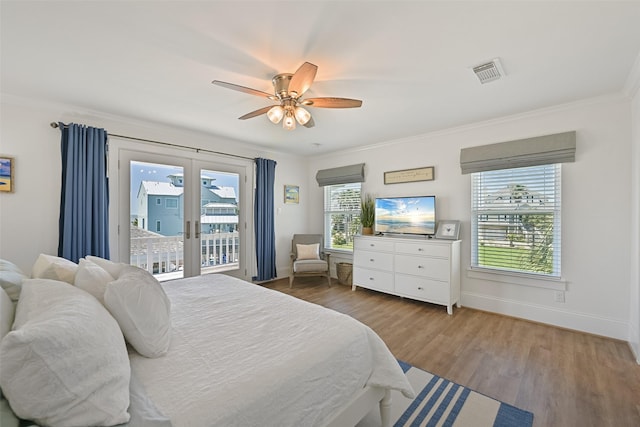 bedroom with visible vents, access to exterior, wood finished floors, and baseboards