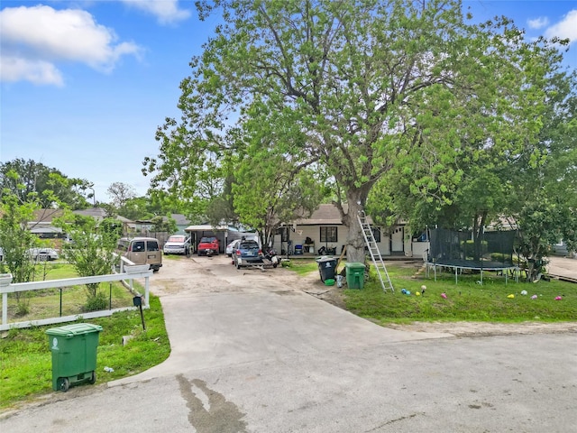 6109 Wayland St, Houston, TX 77021 - view of front of home featuring concrete driveway, a front lawn, and a trampoline
