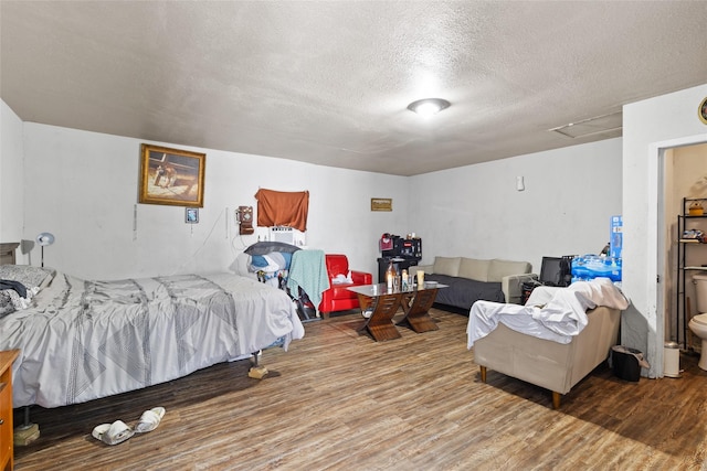 6109 Wayland St, Houston, TX 77021 - bedroom featuring a textured ceiling, wood finished floors, and attic access