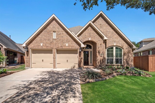 17638 Cleeves Dr, Richmond, TX 77407 - french country style house with brick siding, driveway, and an attached garage