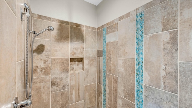 interior details featuring a tile shower