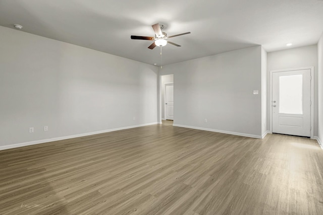unfurnished living room featuring baseboards, recessed lighting, wood finished floors, and a ceiling fan