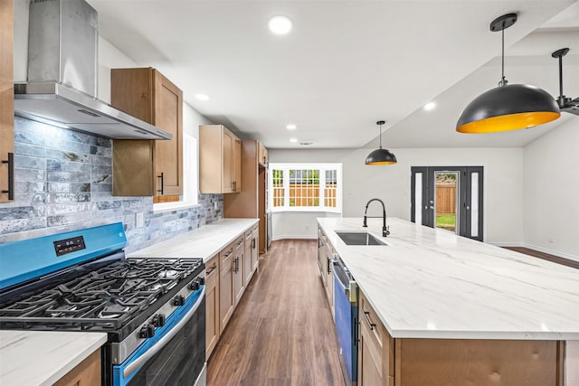kitchen featuring a sink, a spacious island, wood finished floors, exhaust hood, and appliances with stainless steel finishes