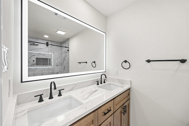 full bathroom featuring visible vents, a marble finish shower, a sink, and double vanity