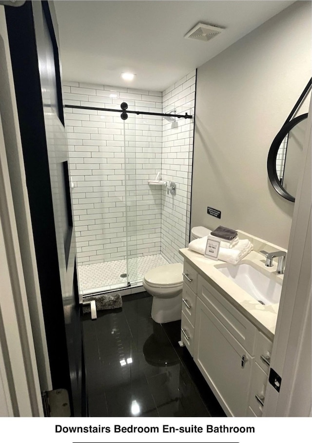 full bathroom with toilet, vanity, visible vents, and a stall shower