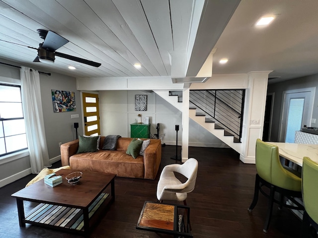 living room featuring ceiling fan, stairway, baseboards, and wood finished floors