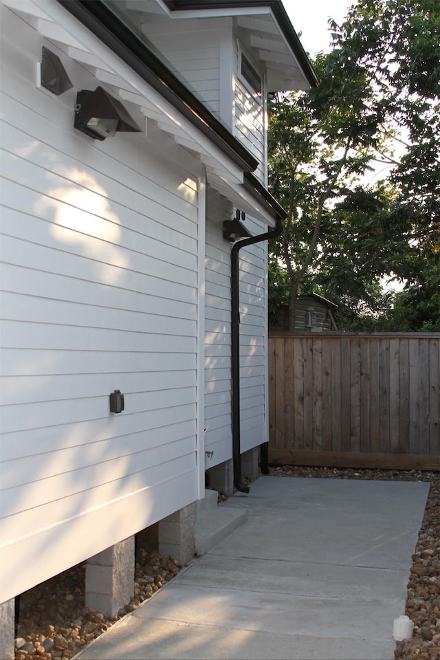 view of side of property featuring fence and a patio area