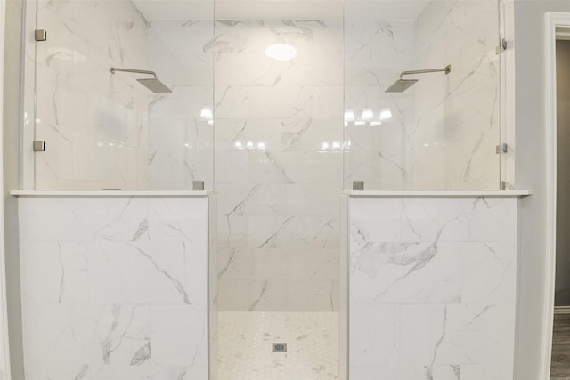 full bath featuring a marble finish shower
