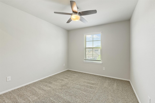 empty room with carpet floors, ceiling fan, and baseboards