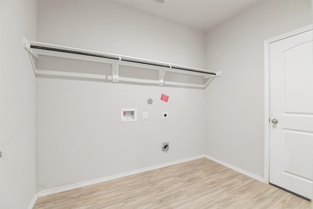 clothes washing area with electric dryer hookup, hookup for a washing machine, light wood-style flooring, and baseboards