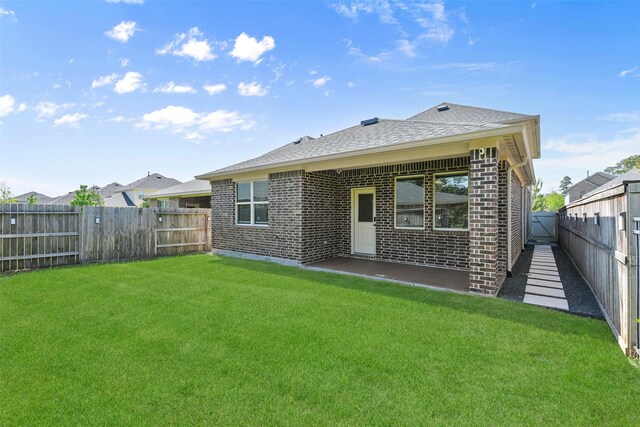 back of property with brick siding and roof with shingles