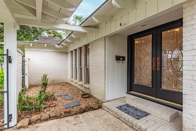 doorway to property with brick siding and french doors