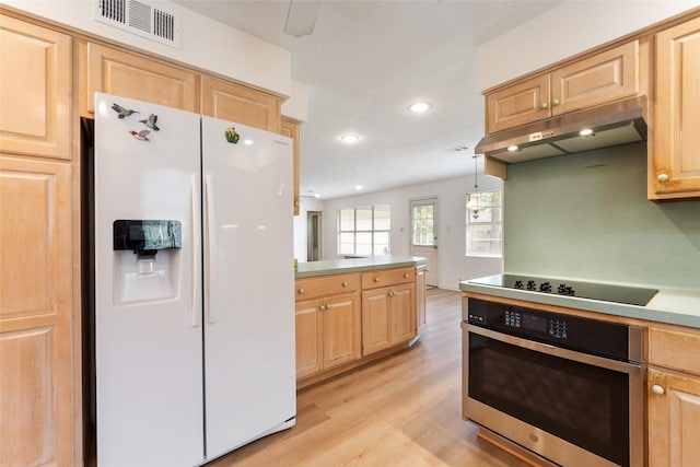 kitchen featuring under cabinet range hood, visible vents, black electric stovetop, stainless steel oven, and white refrigerator with ice dispenser