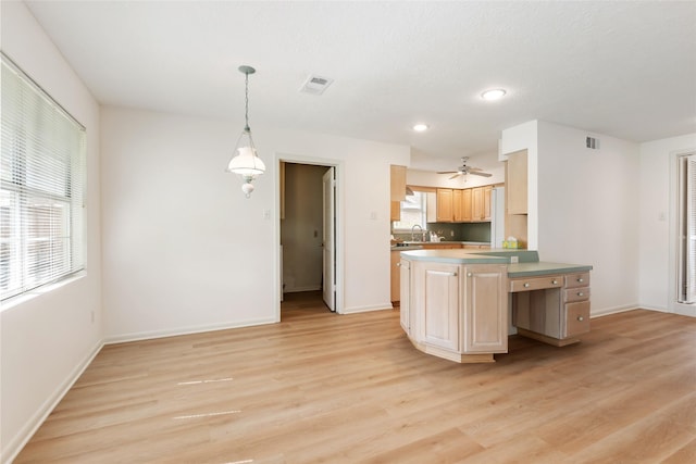 kitchen featuring light wood-type flooring, baseboards, visible vents, and ceiling fan