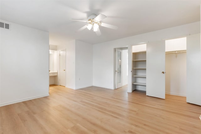 unfurnished bedroom featuring a ceiling fan, baseboards, visible vents, and light wood finished floors