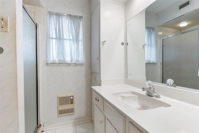 full bathroom featuring heating unit, a stall shower, vanity, tile patterned flooring, and visible vents