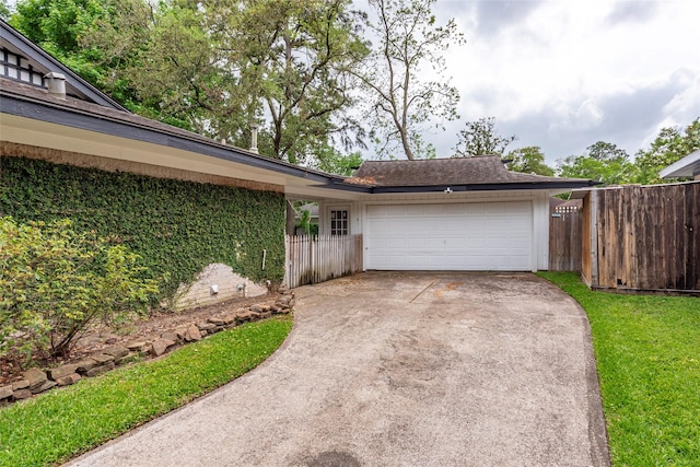 exterior space featuring driveway and fence