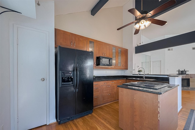 1904 Portsmouth St, Houston, TX 77098 - kitchen with ceiling fan, a peninsula, black appliances, a sink, and brown cabinets