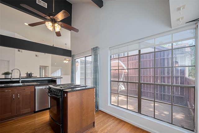 1904 Portsmouth St, Houston, TX 77098 - kitchen with stainless steel dishwasher, a ceiling fan, gas stove, a sink, and dark countertops