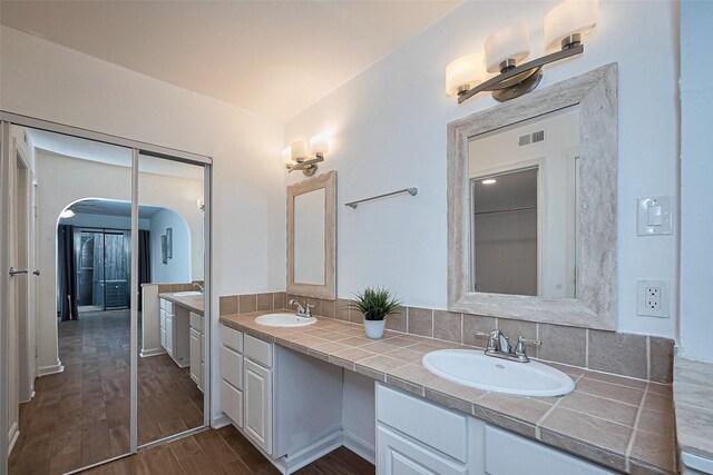 1904 Portsmouth St, Houston, TX 77098 - full bathroom featuring double vanity, visible vents, a sink, and wood finished floors