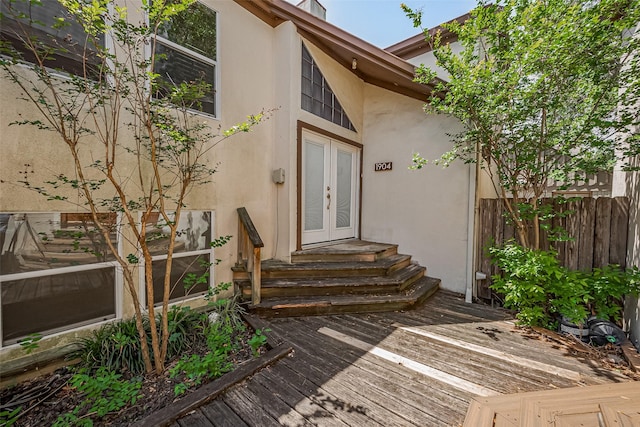 1904 Portsmouth St, Houston, TX 77098 - view of exterior entry featuring french doors, fence, a wooden deck, and stucco siding