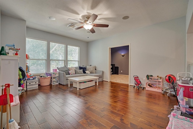 living room with ceiling fan and wood finished floors