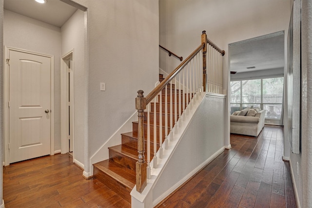 stairway with hardwood / wood-style flooring and baseboards
