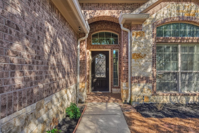 entrance to property with brick siding and stone siding