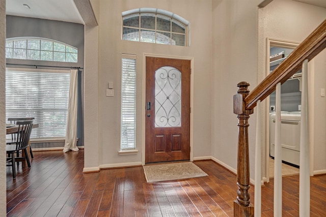 foyer with dark wood-style floors and baseboards
