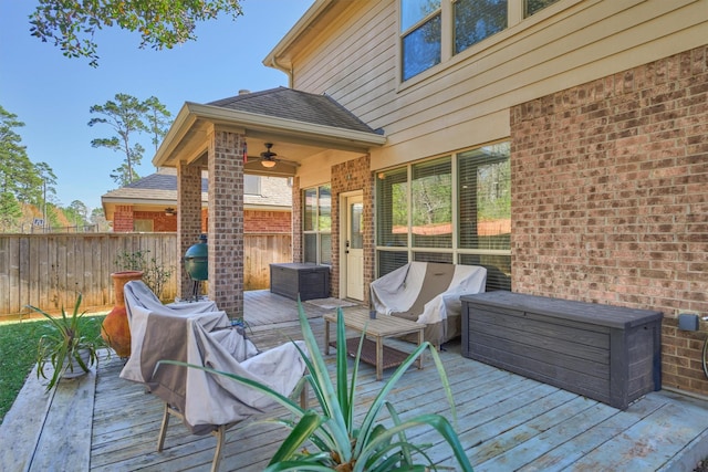 deck with a ceiling fan, fence, a grill, and outdoor lounge area
