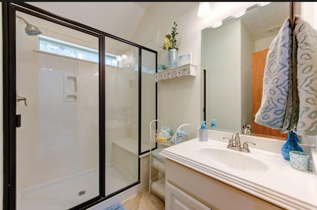 full bath with tile patterned floors, vanity, and a stall shower
